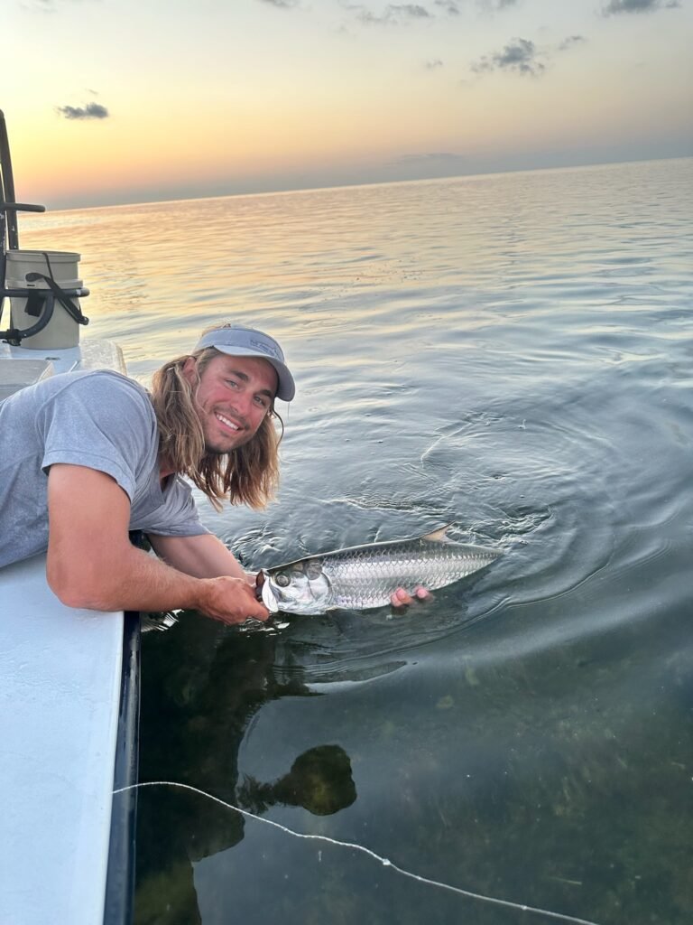 Angler holding a juvenile tarpon in Key West waters