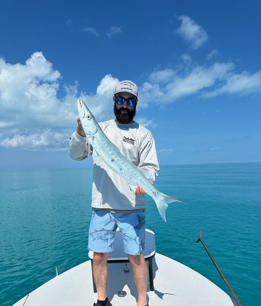 Angler holding a barracuda caught in Key West waters