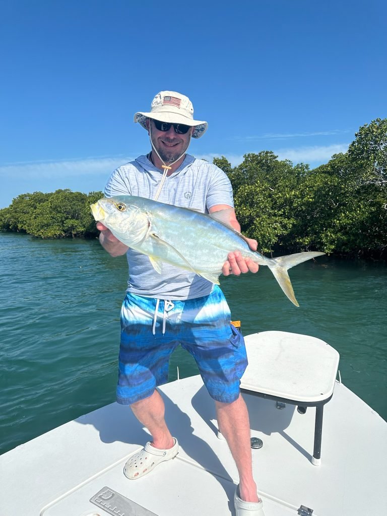 Angler holding a jack crevalle in Key West backcountry