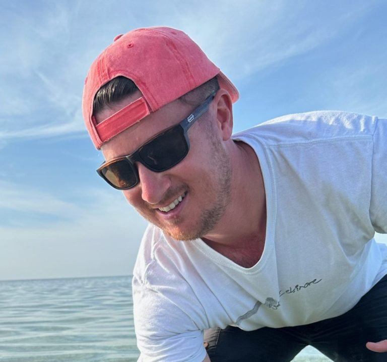 Will P smiling on a fishing trip in the shallow waters of Key West